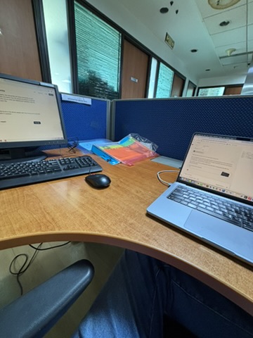 A desk with two computers at the Jubilant office